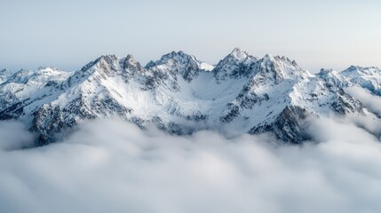 Fototapeta premium Snowy Mountain Peaks Above Clouds