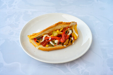 Close-up shot of Izmir's famous Turkish Traditional Kumru Sandwich, Ceşme Kumru, patso ingredients ready to eat salami, soudjouk, tomato, cheddar cheese and fried cheese. Yengen sandvic. Izmir karisik