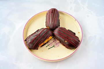 Ekler Pasta Turkish delicious ekler pasta with plate. Klasik, cikolatali, muzlu, frambuazli, karamelli, cilekli, oreolu ekler.