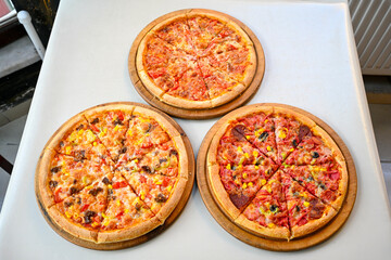 Traditional Turkish cuisine. Pizza, pita, pidesi, sucuk, hummus, kebab. Many dishes on the table. Serving dishes in restaurant. Margherita,  mix, formaggi, veggie karisik pizza. Top view, flat lay