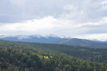 Fototapeta premium Clouds coming in over the rocky mountains