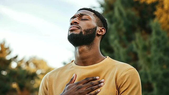 Man Holding Stomach Depicting Nausea as a Symptom