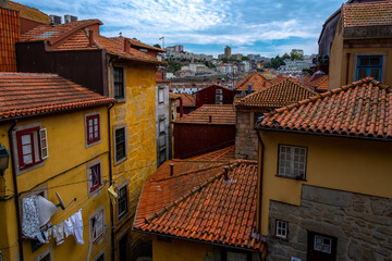A shot of different yellow buildings with orange roofs