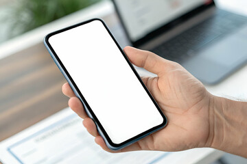 Person Holding Mobile Phone With Empty Display In Office Workspace