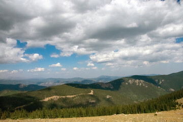 Fototapeta premium Clouds rising over the Mountains From Mt. Blue Sky 
