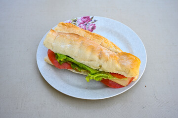 Close-up shot of Izmir's famous Turkish Traditional Kumru Sandwich, Ceşme Kumru, patso ingredients ready to eat salami, soudjouk, tomato, cheddar cheese and fried cheese. Yengen sandvic. Izmir karisik