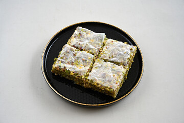 Turkish Dessert Sobiyet, havuc dilimi, midye baklava, mussels baklava and classic baklava with Pistachio . Cikoltali cevizli, fistikli soguk Baklava, top view.