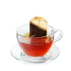 Putting tea bag into glass cup on white background