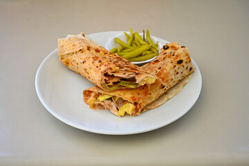 Lavash doner kebab ( soslu kasarli zurna doner durum )  or shawarma sliced in plate isolated.  Tavuk Et Doner Durum. Hatay Iskenderun usulu bazuka tavuk doner durum. 