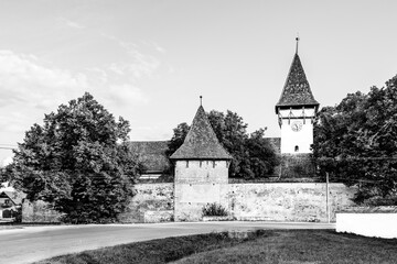 Fortified evangelical church of Cincsor village near Fagaras in Brasov county, Transylvania, Romania; Traditional saxon fortified church of Transylvania in black and white