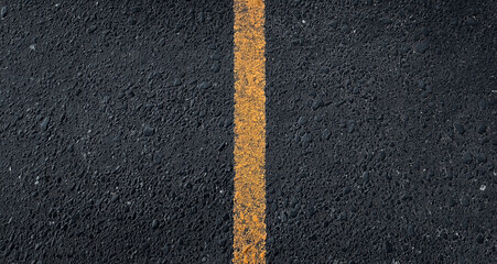 Fototapeta premium A black asphalt background with a smooth road texture, viewed from the top. The surface has fine grainy particles, creating a realistic and detailed look. High-quality design with ample copy space for