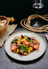 Gourmet beef cubes with roasted potatoes, cherry tomatoes and spinach with rich sauce and wine