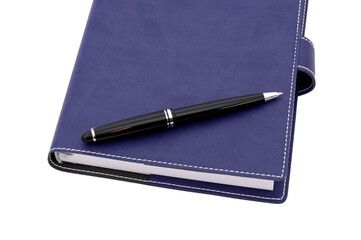 ballpoint pen is laying on the notebook