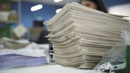 Large stack of documents on desk