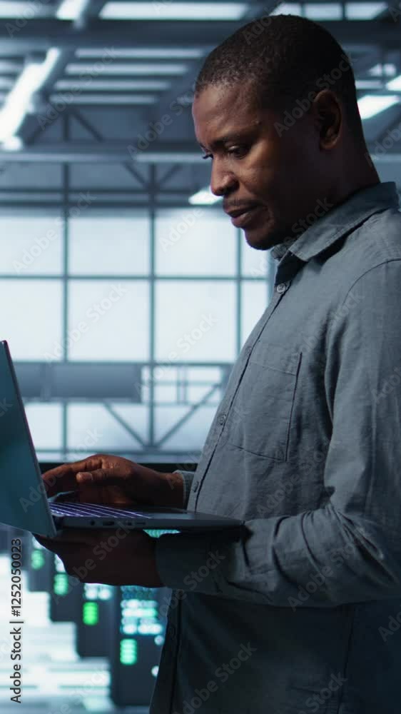 Poster vertical video portrait of happy system administrators in data center using devices, verifying firew