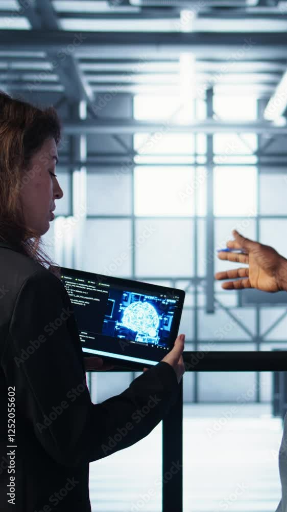 Poster vertical video data center technicians deploying ai driven management tools using tablet. server far