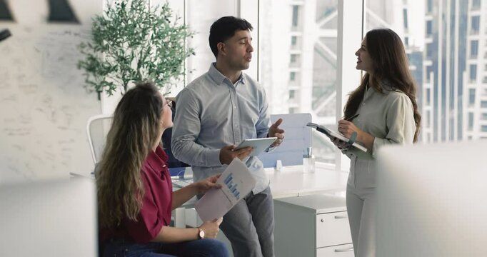 Teammates lead collaborative and informal discussion in modern workplace, engaging in teamwork, ideas exchange, presenting or explaining data, reviewing or provide feedback, brainstorming key points