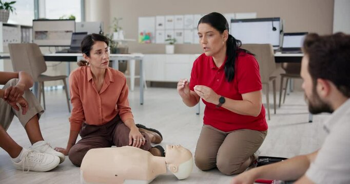 Cpr, teaching and mannequin with woman and training for First aid, workshop or learning. Healthcare, safety course and emergency with people in class for paramedic demonstration, instructor or rescue