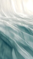 Fototapeta premium Serene Drape: Soft, flowing fabric in shades of teal and white creates a calming, minimalist image, ideal for backgrounds or design elements.