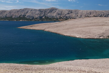 The beach and the rocks and the moon-like landscape of the island of Pag, Croatia.	