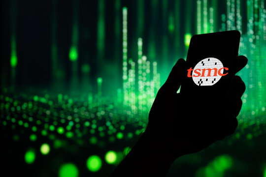 TSMC Taiwan Semiconductor logo on smartphone screen, technology, AI artificial intelligence and cyberspace concept green data background. NYSE: TSM logotype, Puebla, Mexico, December 22, 2024
