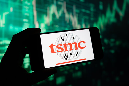 TSMC Taiwan Semiconductor logo on smartphone screen, green stock market chart going up at the background, semi-conductor microchip maker, Puebla, Mexico, December 22, 2024