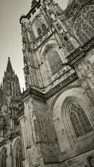A black and white photography capturing the intricate details of a Gothic cathedral's facade in...