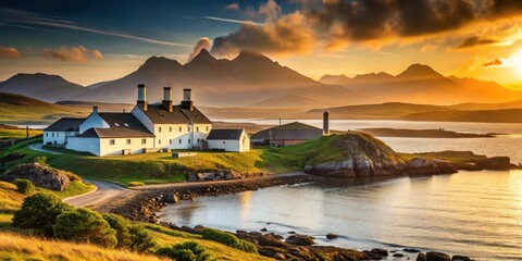 Fototapeta premium Distillery on misty Islay island at sunset with rugged mountains and sea in the background, whisky distillery, misty landscape