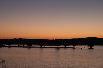 Naklejka premium Beautiful lakeside view with sky night and day