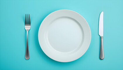 Simple Table Setting with White Plate, Fork and Knife on Turquoise Background