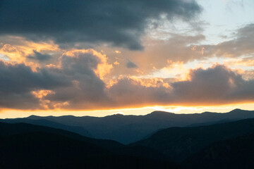 Fototapeta premium Glowing Clouds at Sunset Over Rocky Mountains
