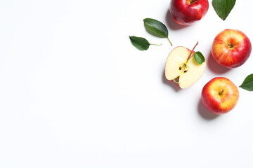 Flat lay composition with whole and cut apples on white background. Space for text