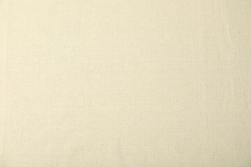 Texture of beige tablecloth as background, top view