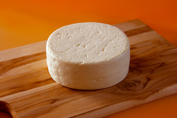 WHOLE FRESH CHEESE - MINAS GERAIS ON WOODEN BOARD AND ISOLATED BOTTOM - TRADITIONAL CHEESE FROM MINAS GERAIS