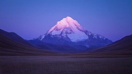 Fototapeta premium Majestic Snowcapped Mountain at Dusk Over Rolling Hills
