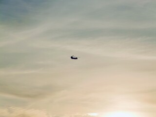 Helicopter fly on sunset lights near the coast of the Saronic Gulf in the Athens Riviera, Piraeus, Greece