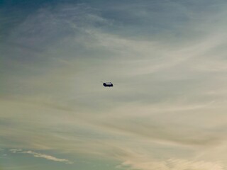 Helicopter fly on sunset lights near the coast of the Saronic Gulf in the Athens Riviera, Piraeus, Greece