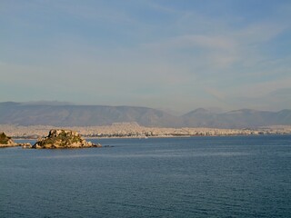 View of the seaside and Hymettus or Hymettos, a mountain range in the Athens area of Attica, from the Votsalakia beach, Piraeus, Greece