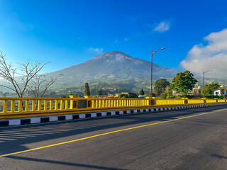 View of the bridge with the mountain in the background. Sigandul Bridge and Mount Sumbing.