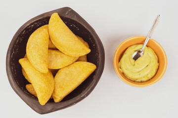 Colombian empanada with spicy sauce 

