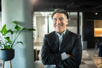 Portrait of a confident smiling businessman in modern office