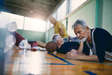 Senior men exercising and bonding in gym setting