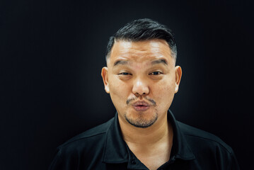 Asian man mouth whistle on background dark style