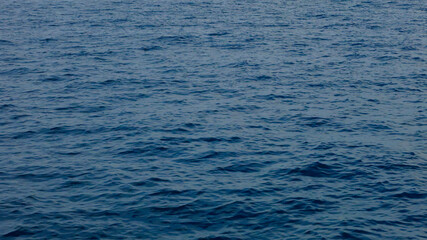 Calm sea surface. View of the smooth surface of the blue sea.