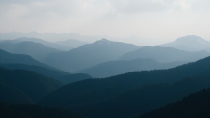 Fototapeta premium Serene Mountain Landscape with Misty Peaks and Rolling Hills