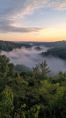 Fototapeta premium Rolling fog over forested hills at sunrise, misty morning over hills. Vertical