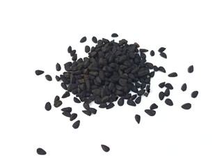 Black cumin seeds pile isolated on white background