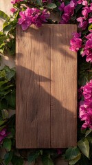 Fototapeta premium Wooden board framed by bougainvillea, sunlight, mockup