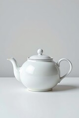 a close up of a white teapot on a table