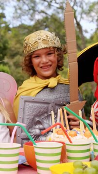 Group of kids in various costumes having breakfast